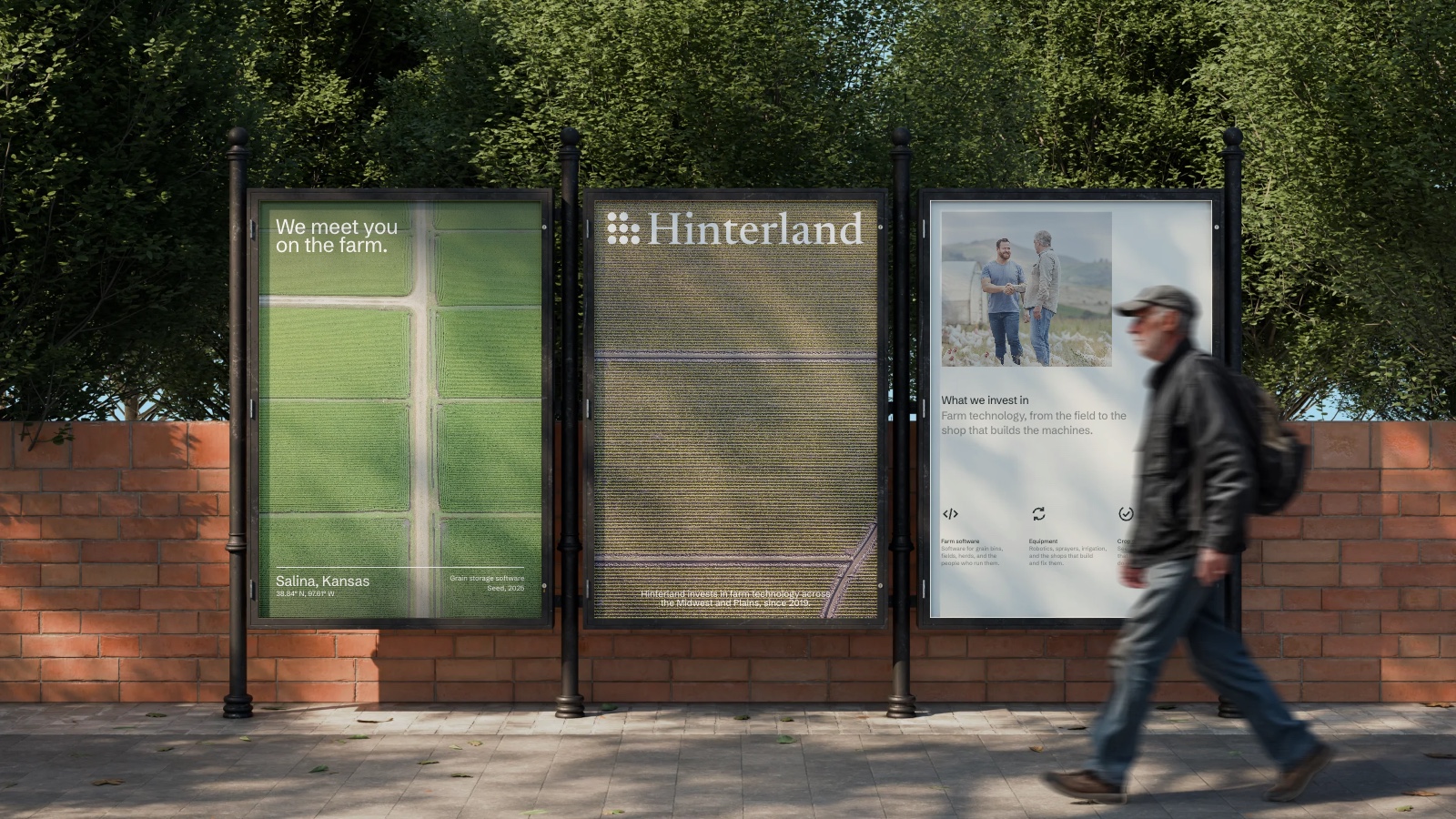 Three Hinterland posters outdoors on a brick wall