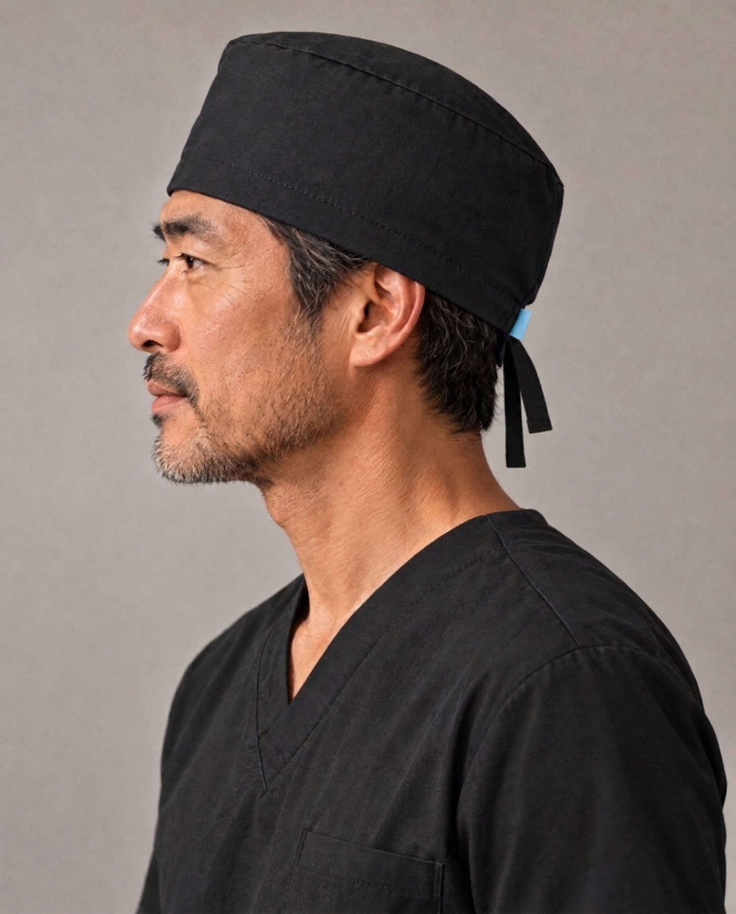 A technologist in profile, in a scrub cap