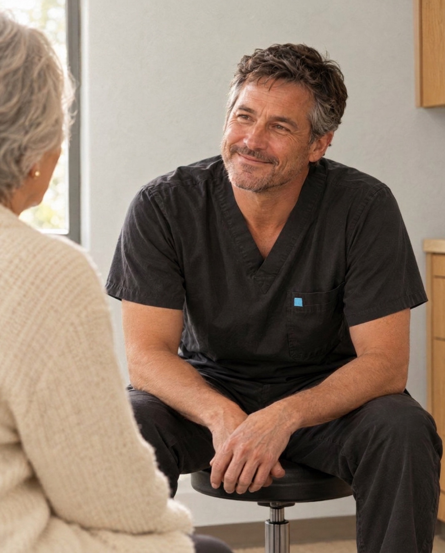 The doctor listening to an older patient